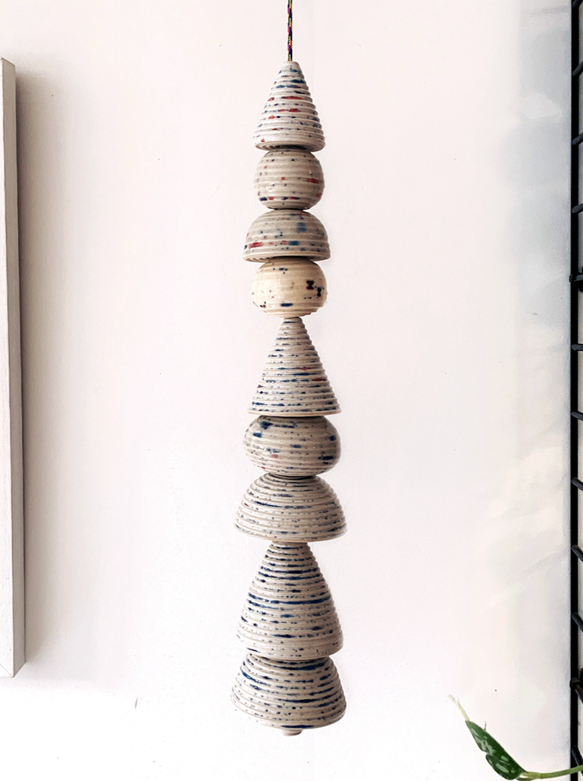 A hanging ceramic layered ornament, Christmas decoration, speckled, shapes